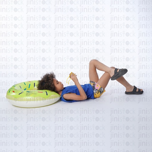 little egyptian boy sleeping on his back and  his head on a water floater