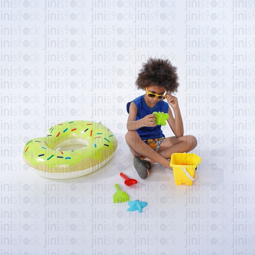 little Egyptian boy playing with sand toys