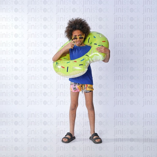 young egyptian boy with curly hair wearing water floater and sun glass standing