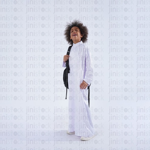 saudi khaliji boy standing carrying his school bag happy laughing