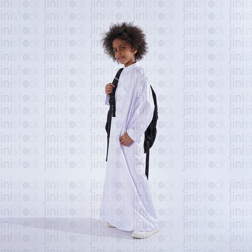 Khaliji saudi boy with curly hair from gulf carrying his school bag