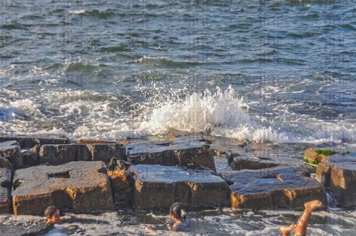A beach, water splash and waves in Alexandria- Alexandria Corniche beach at sunset