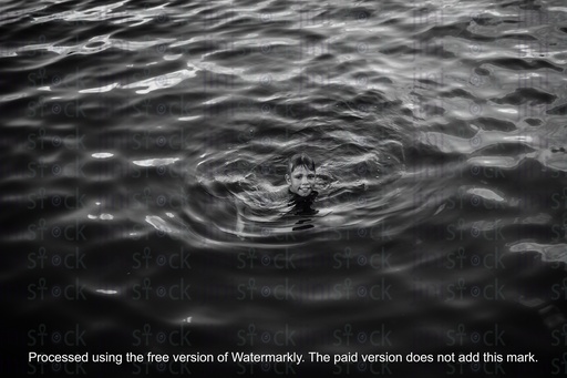 egyptian boy swimming in the nile in black and white