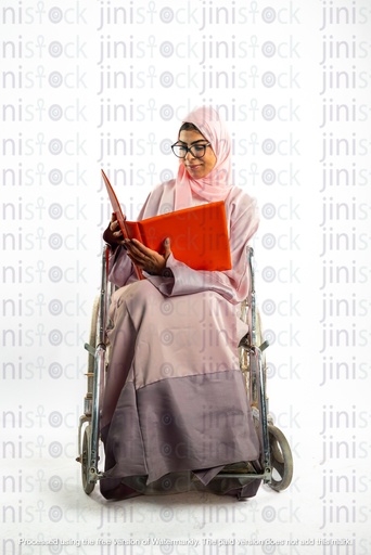 saudi khaliji woman from the gulf on a wheel chair disabled looking at a work folder or file