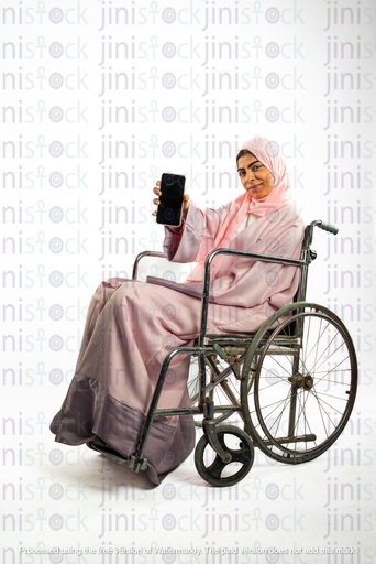 saudi khaliji woman on a wheelchair  holding mobile phone facing the camera