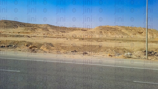 mountains and an empty Road with no cars or buses or any transportations on a traveling road in Egypt