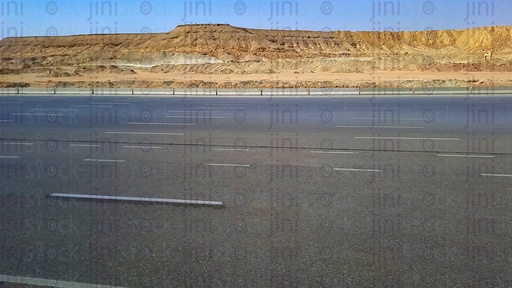 mountains and an empty Road with no cars or buses or any transportations on a traveling road in Egypt