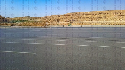 Mountains and an empty Road with no cars or buses or any transportations on a traveling road in Egypt