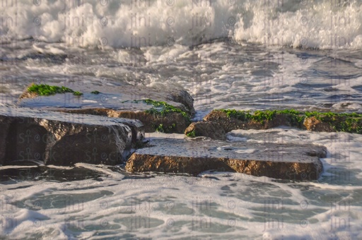 A beach, water splash and waves in Alexandria- Alexandria Corniche beach at sunset.