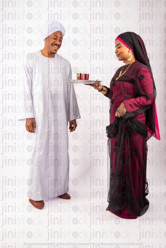 Nubian Egyptian man and woman serving tea on a tray