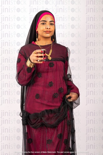 Nubian Egyptian woman drinking tea and looking to the camera