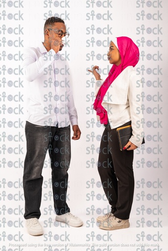 A veiled Nubian girl standing talking with a Nubian young man drinking coffee