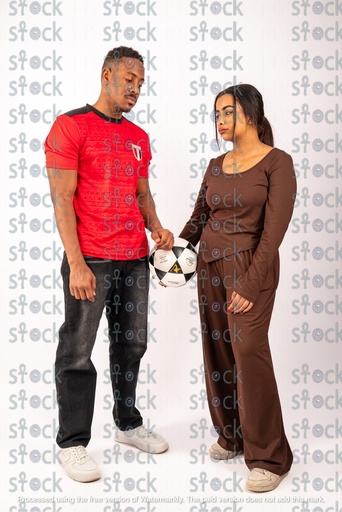 Young man and woman holding a football