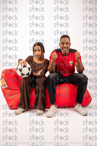 A red bean bag with Nubian football fans sitting on it