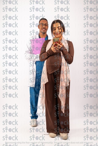 The mother in front of the doctor looks at the phone with a smile