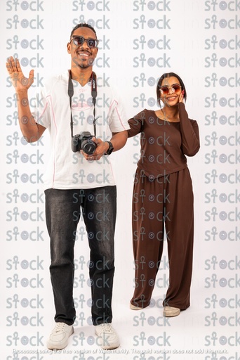 The Nubian youth waves happily to the camera and the girl is amazed