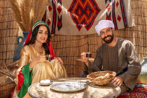 An Egyptian farmer drinks tea with his wife 