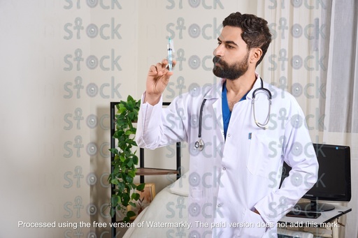 Doctor holding a medical syringe