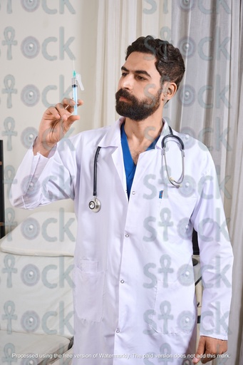 Doctor wearing medical coat and stethoscope holding syringe