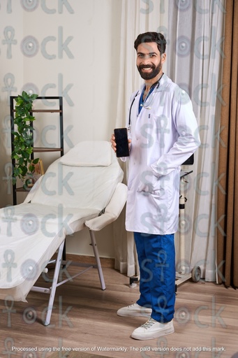 Egyptian doctor standing smiling and holding his phone