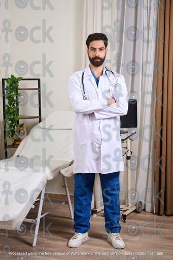 Egyptian doctor standing wearing a medical coat and stethoscope