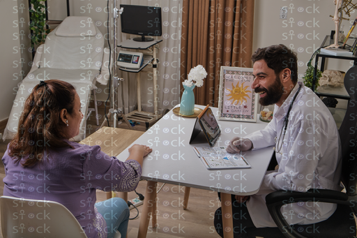 Doctor showing report to patient 