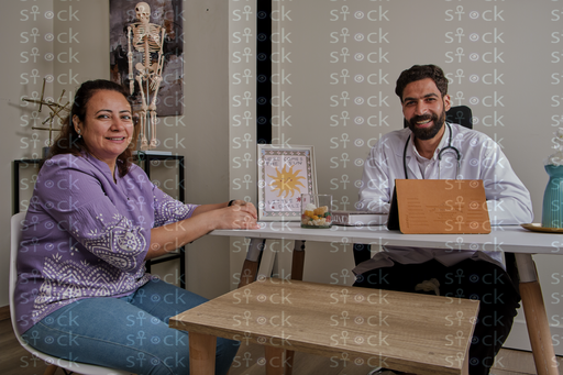 Patient smiling with doctor at desk